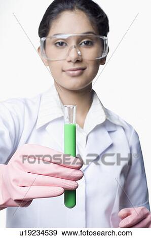 Portrait of a female scientist showing a test tube and smiling in a laboratory View Large Photo Image Stock Photo - Portrait of a female scientist showing a test tube and smiling in a laboratory. Fotosearch