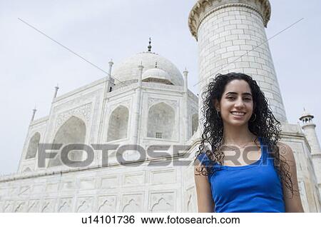 Portrait of a young woman standing in front of a mausoleum, Taj Mahal, Agra, Uttar Pradesh, India View Large Photo Image Stock Photograph - Portrait of a young woman standing in front of a mausoleum, Taj Mahal, Agra, Uttar Pradesh, India. Fotosearch
