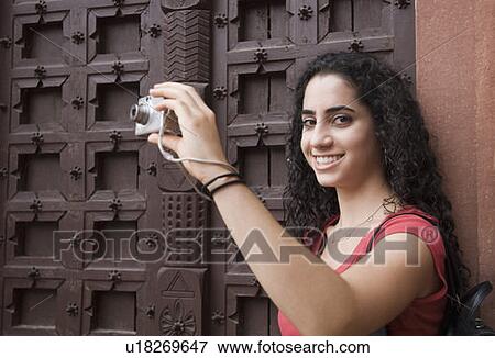 Portrait of a young woman taking a picture with a digital camera, Taj Mahal, Agra, Uttar Pradesh, India View Large Photo Image Stock Photo - Portrait of a young woman taking a picture with a digital camera, Taj Mahal, Agra, Uttar Pradesh, India. Fotosearch