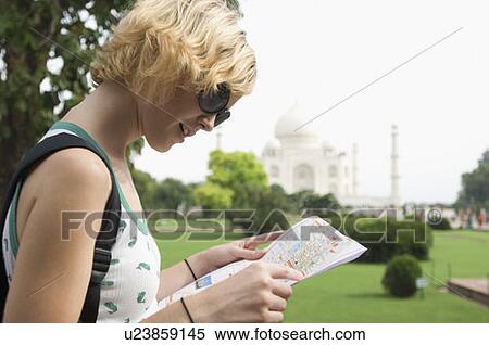 Side profile of a young woman looking at a map, Taj Mahal, Agra, Uttar Pradesh, India View Large Photo Image Stock Photography - Side profile of a young woman looking at a map, Taj Mahal, Agra, Uttar Pradesh, India. Fotosearch